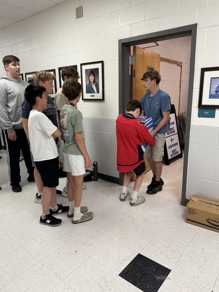 Students helping move books out of the bookroom