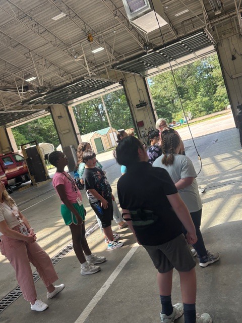 students listening intently at the fire station