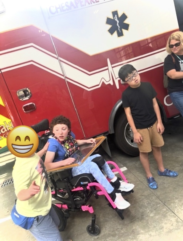 students standing near ambulance excited for their firestation visit
