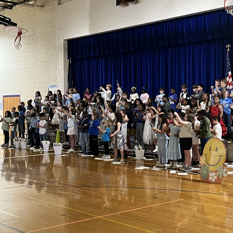 Fourth-grade students performing on stage during their evening music concert.