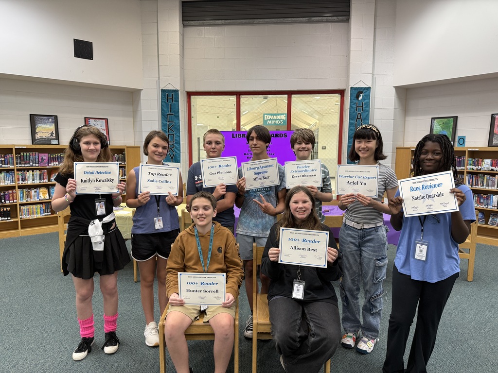 students standing proudly with certificates to honor their contributions to our media center