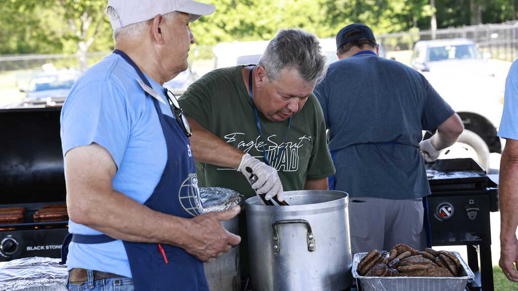 Volunteers work on preparing lunch for the SCA members