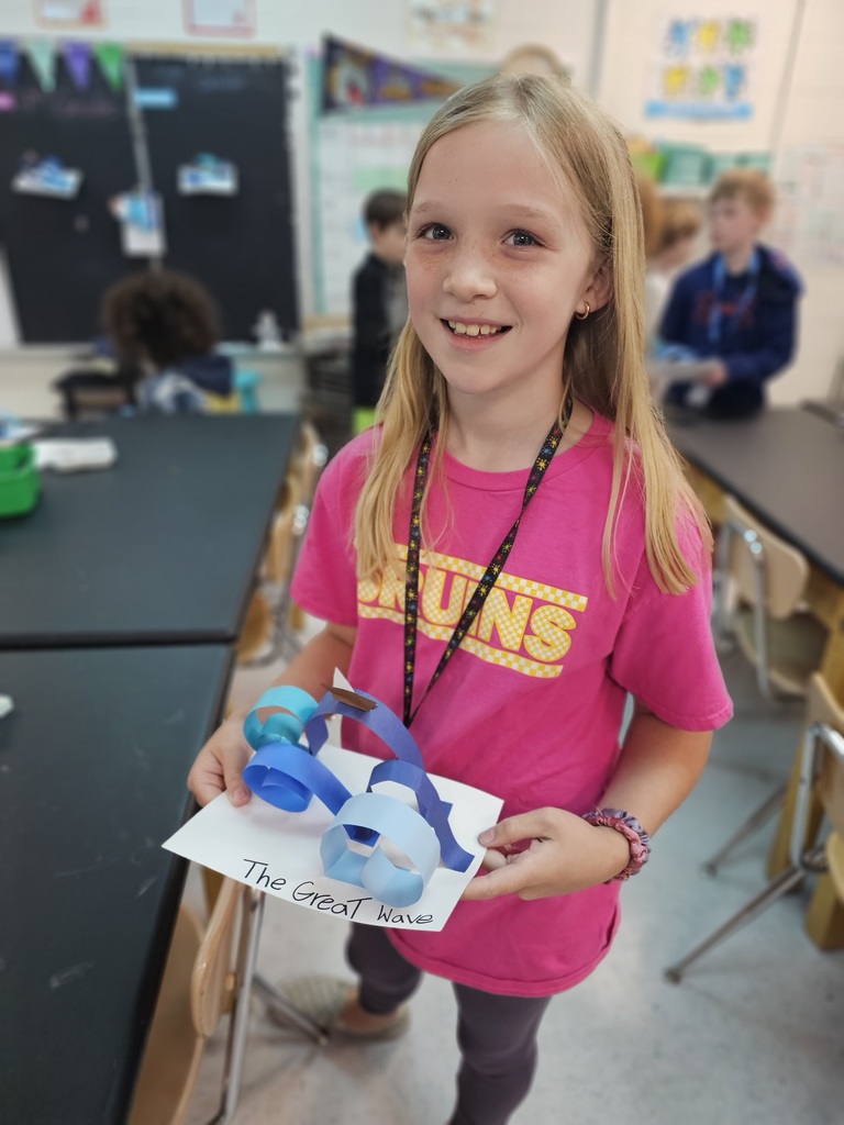 Students with wave sculptures