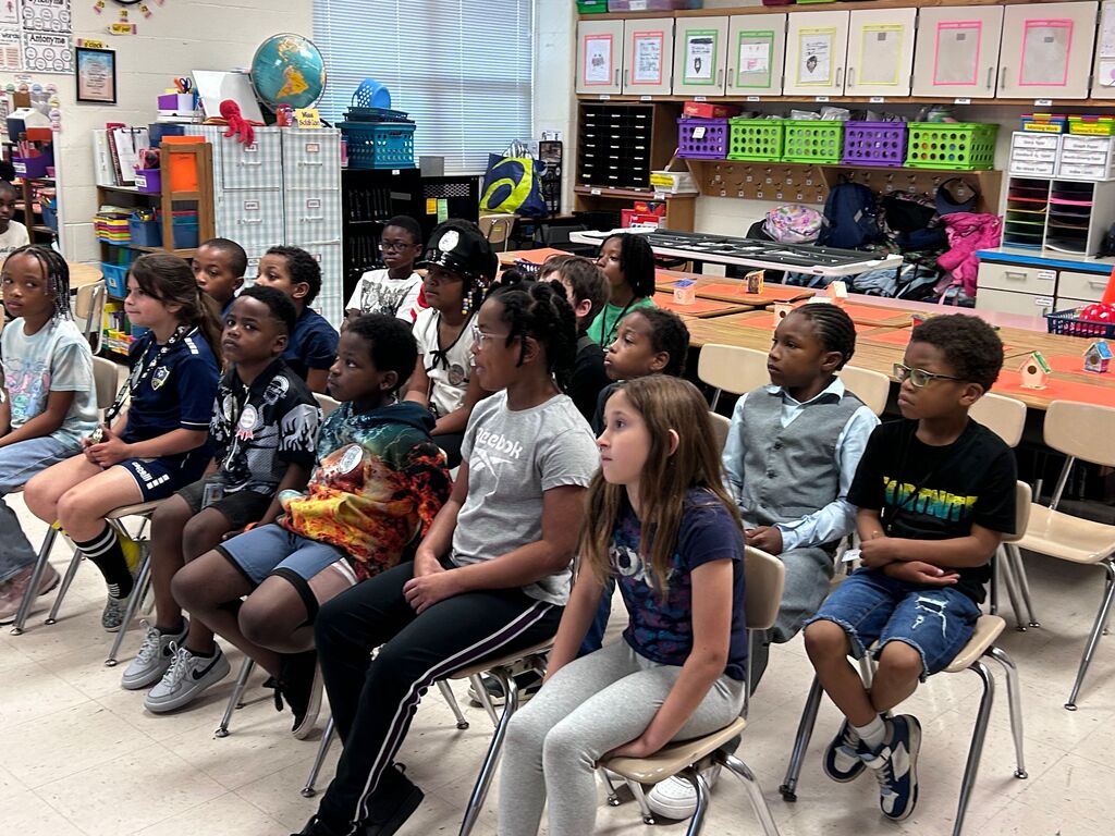 students and presenters at community helpers day