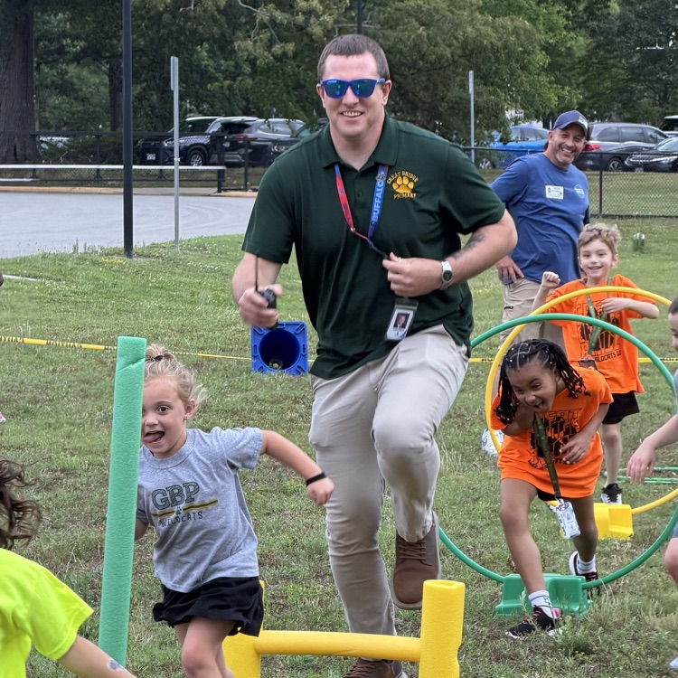 Mr Mason racing with some students on the relay races at field day