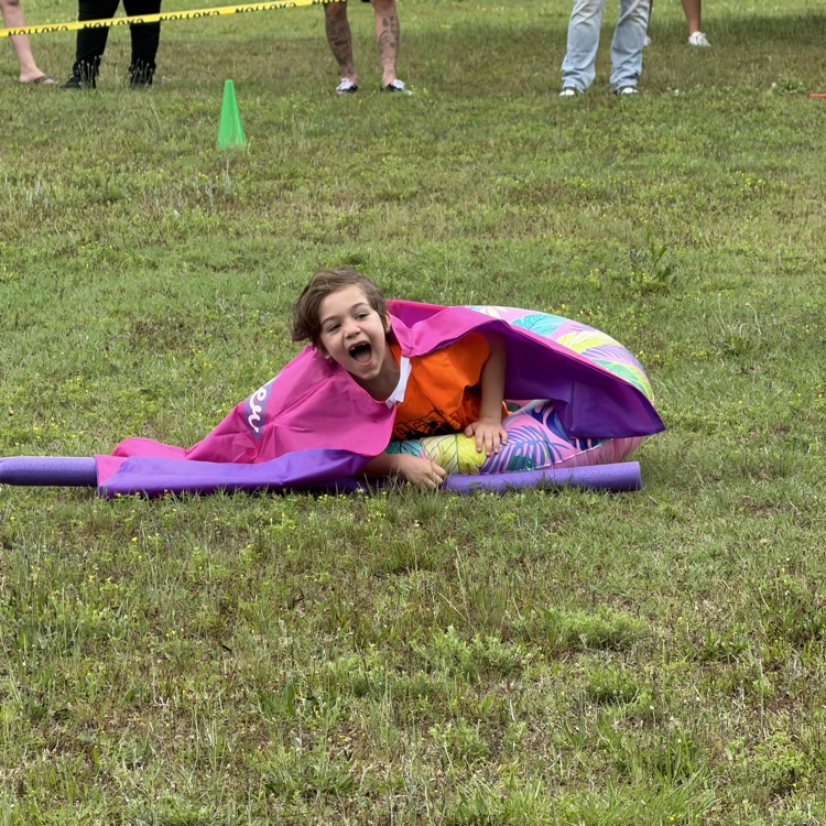 student who fell and is laughing at one of the relays on field day