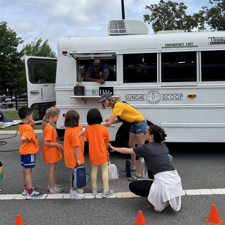 Students waiting to get their yummy treat at the ice cream truck on field day