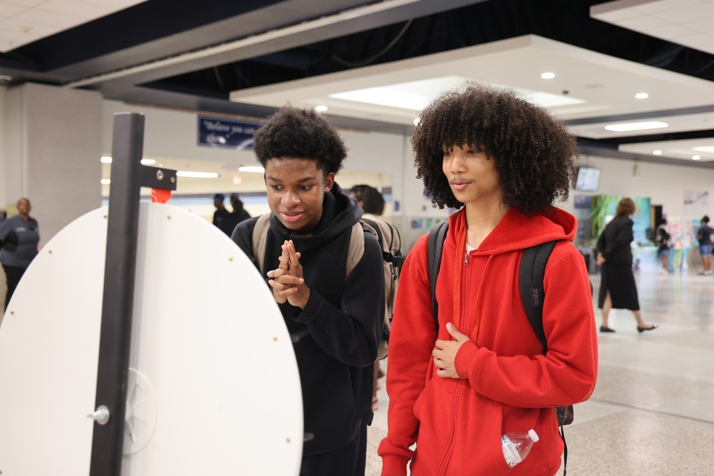 Students at a spinning wheel anticipating what item they will receive.