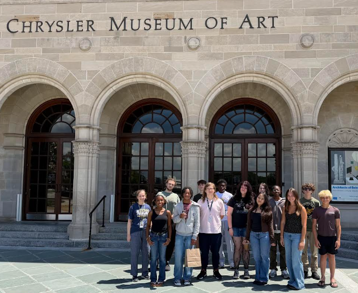 French students smiling in front of museum