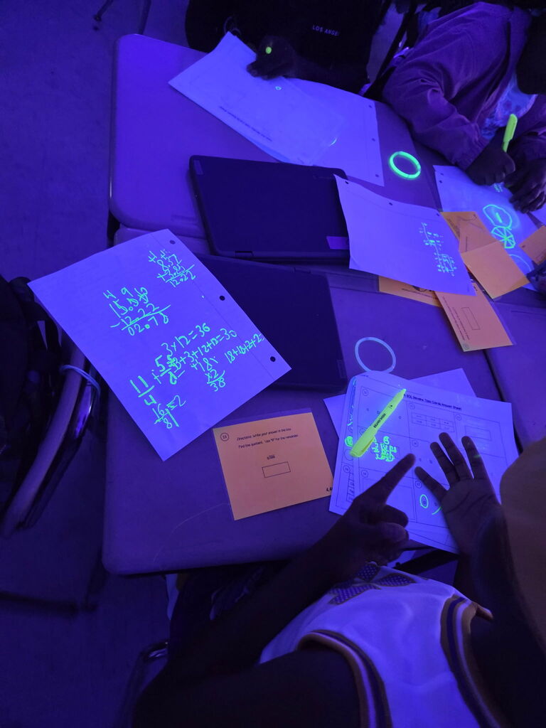 students practicing math in black light