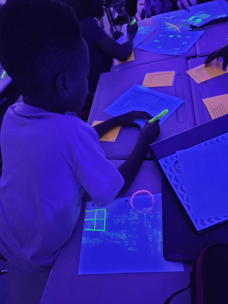 students practicing math in black light
