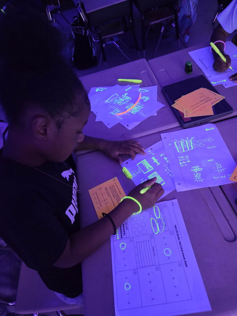 students practicing math in black light