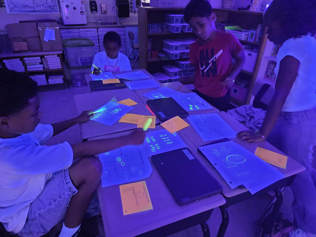 students practicing math in black light