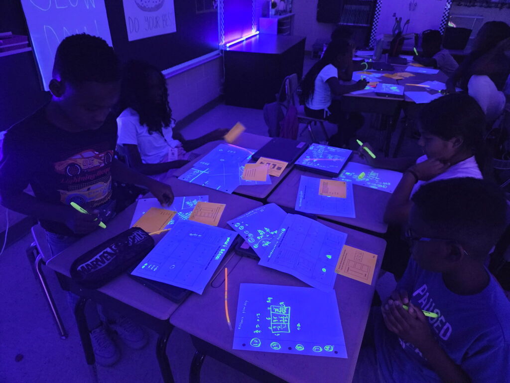 students practicing math in black light