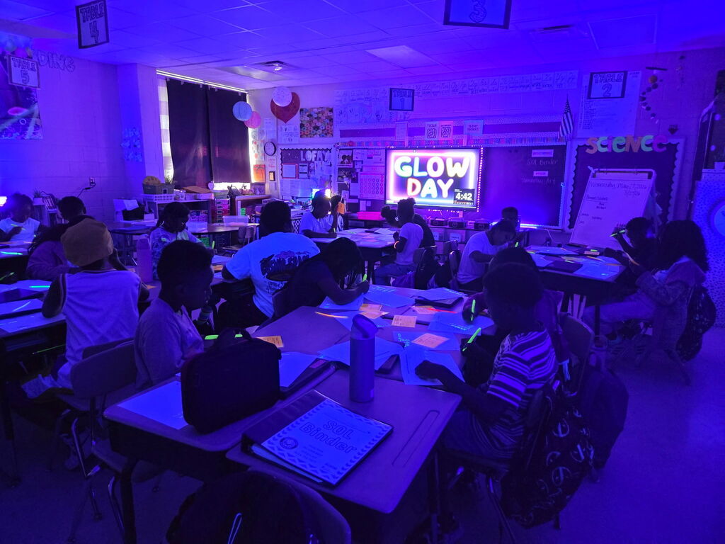 students practicing math in black light