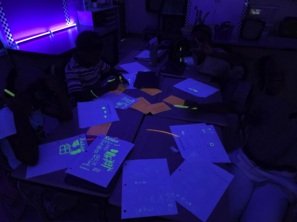 students practicing math in black light