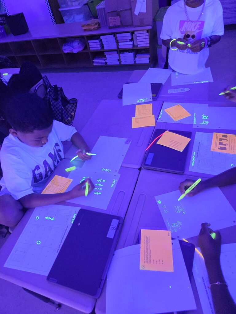 students practicing math in black light