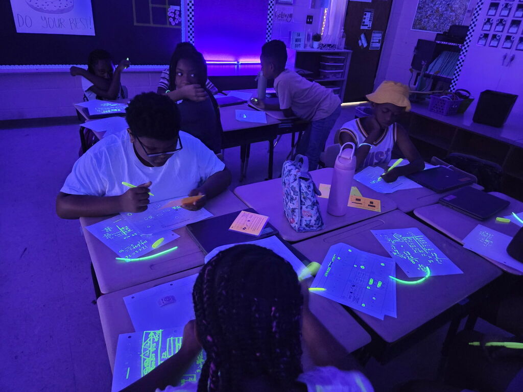 students practicing math in black light