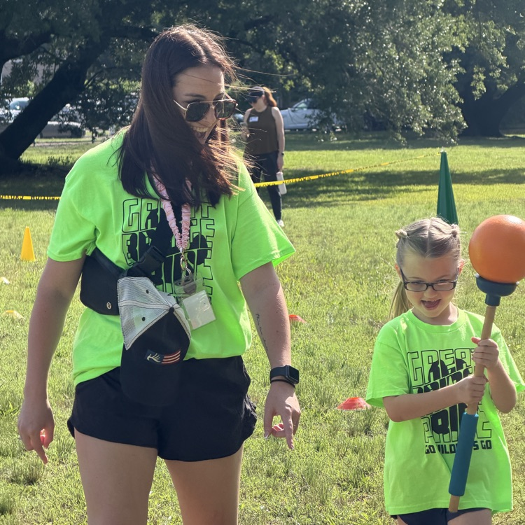 Ms. Thompson helping a student with the plunger relay at field day