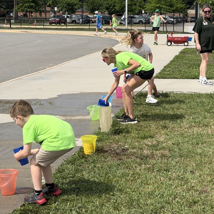 Mrs Warber joking in on the fun at the water relay station at Field Day