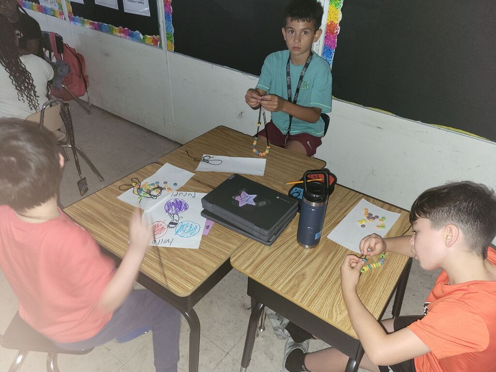 Students making necklaces 