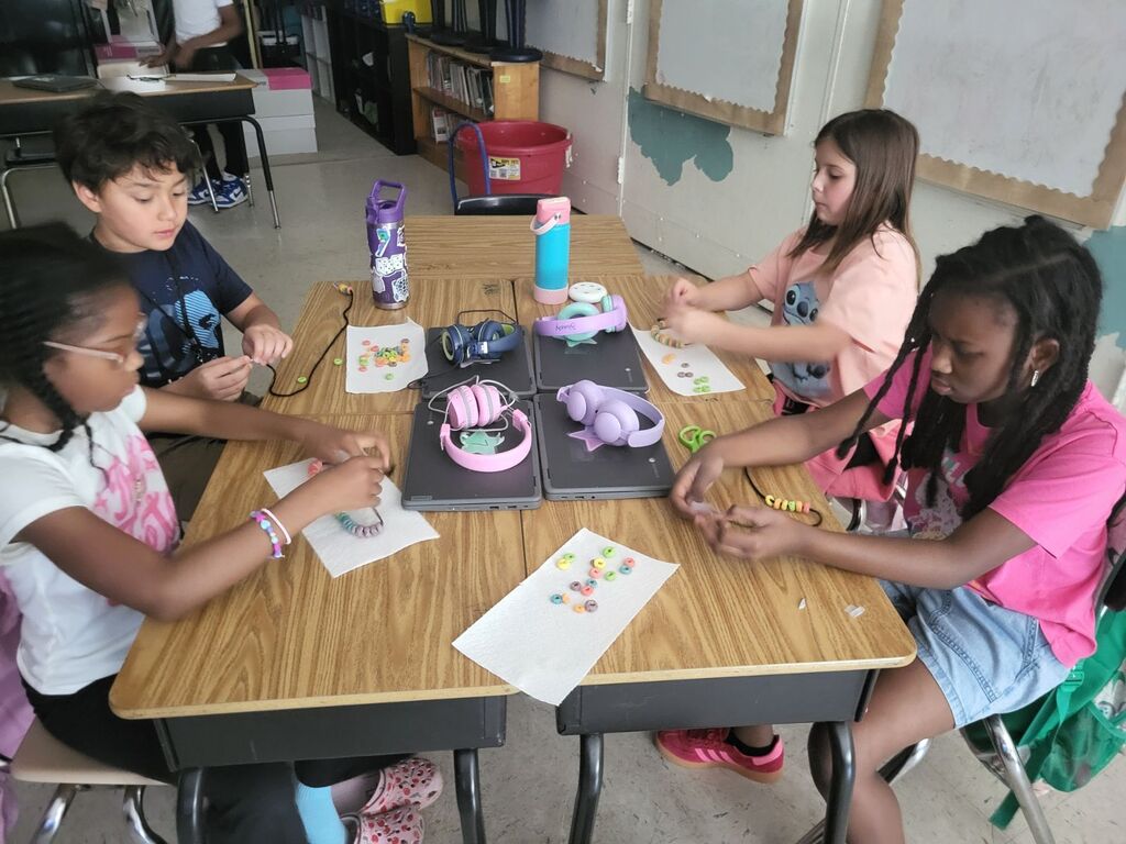 Students making necklaces 