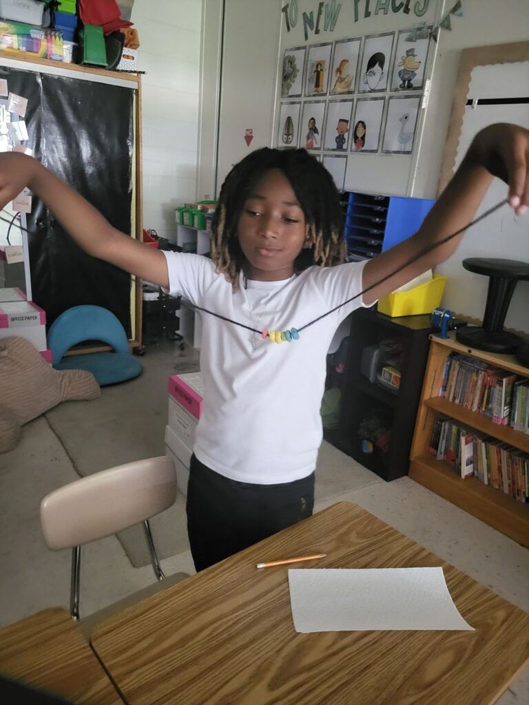 Students making necklaces 