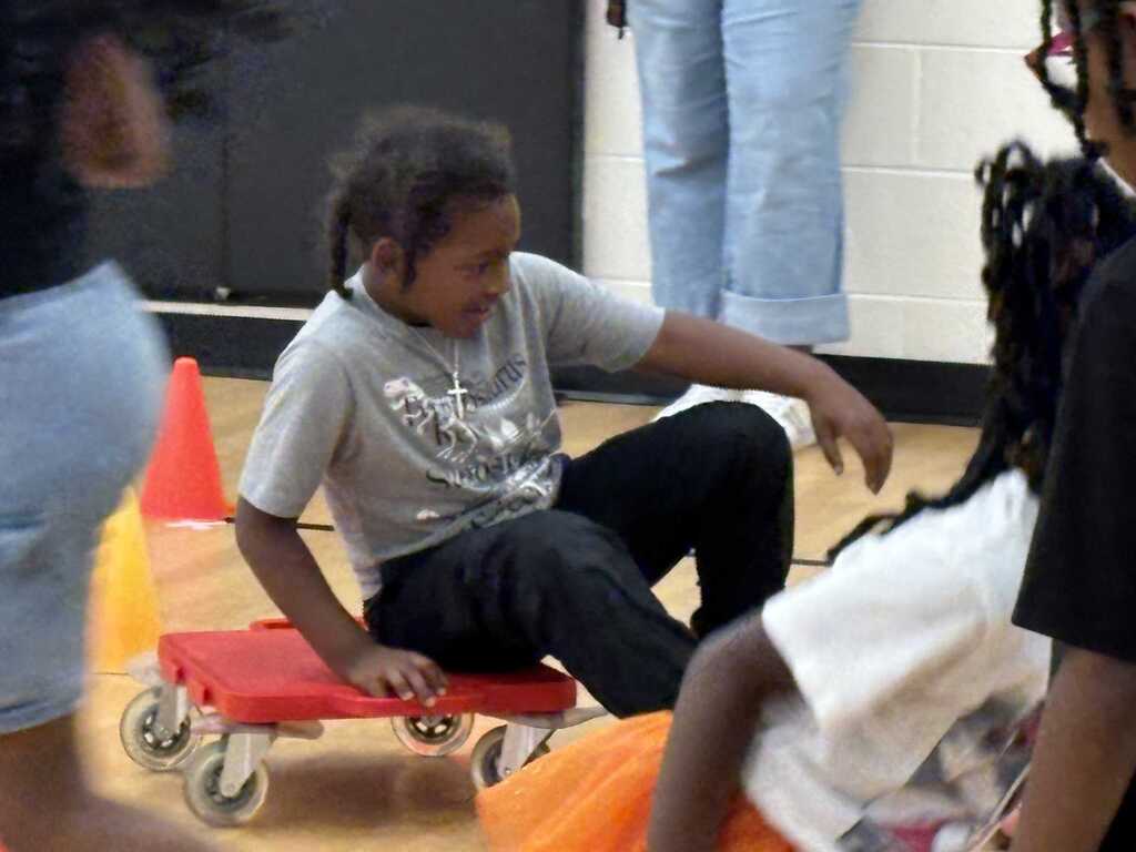 Student on floor scooter