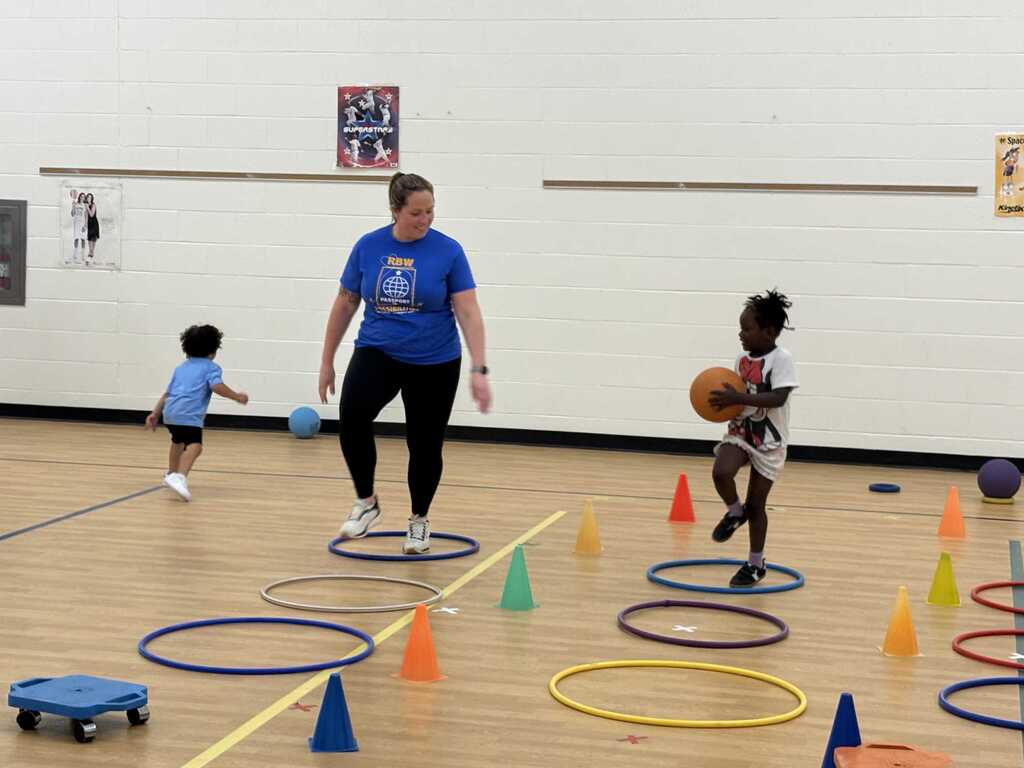 Mrs. Szymborski and a student completing obstacle course