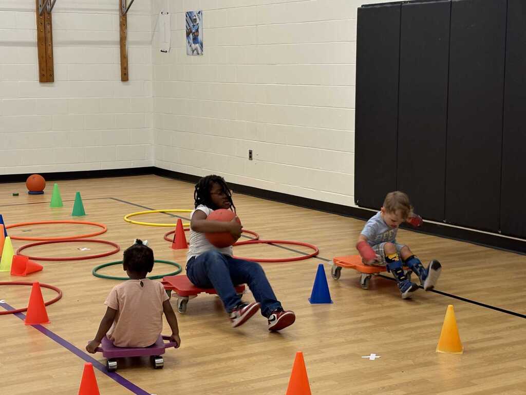 Students on floor scooters.