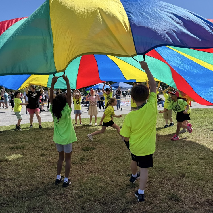 Ms. Shinn’s students enjoying the parachute station at field day