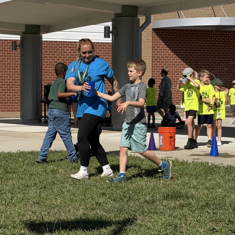 A TA and student at the water relay on field day
