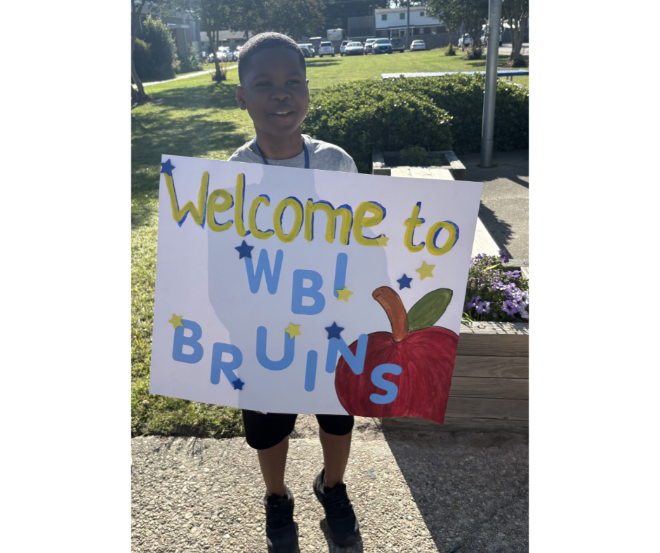 Student holding sign 