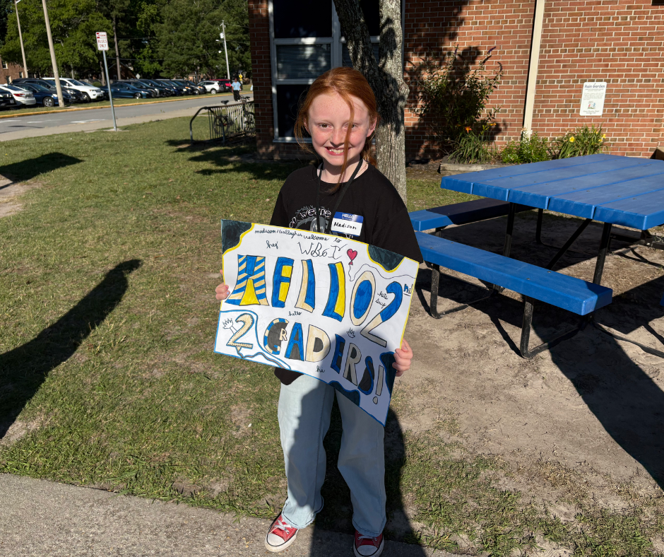 Student holding sign 