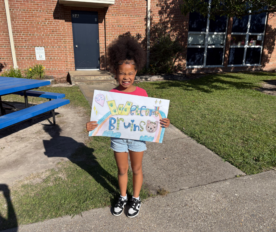 Student holding sign 