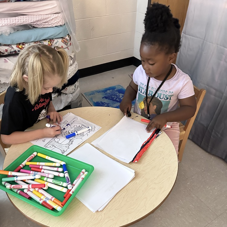 Students coloring a beach picture 