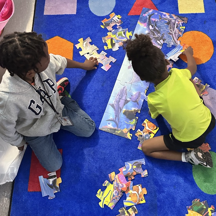 Students working together on an ocean themed puzzle.