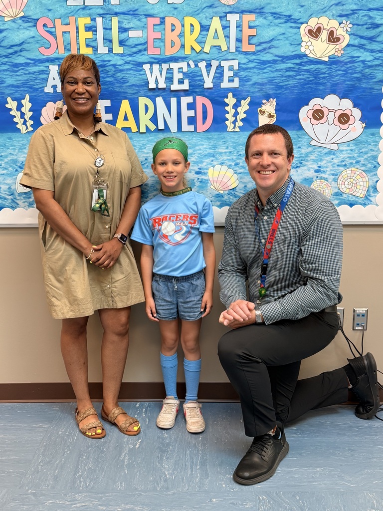 A group of Students of the Month for May posing with the school principal and assistant principal, smiling for the camera in a celebratory recognition photo.