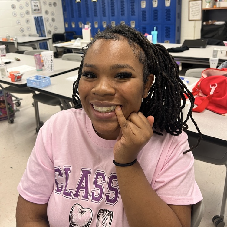 student smiling with tooth gems