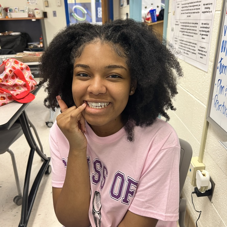 student smiling with tooth gems