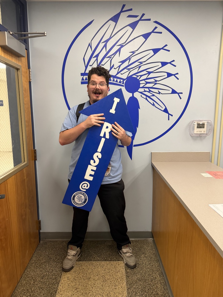 Mr. Hepner excitedly holding up the I RISE arrow.
