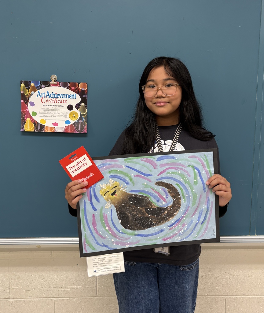student holding her otter painting