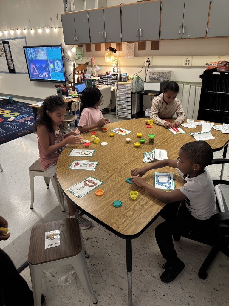 students working on Play-Doh mats