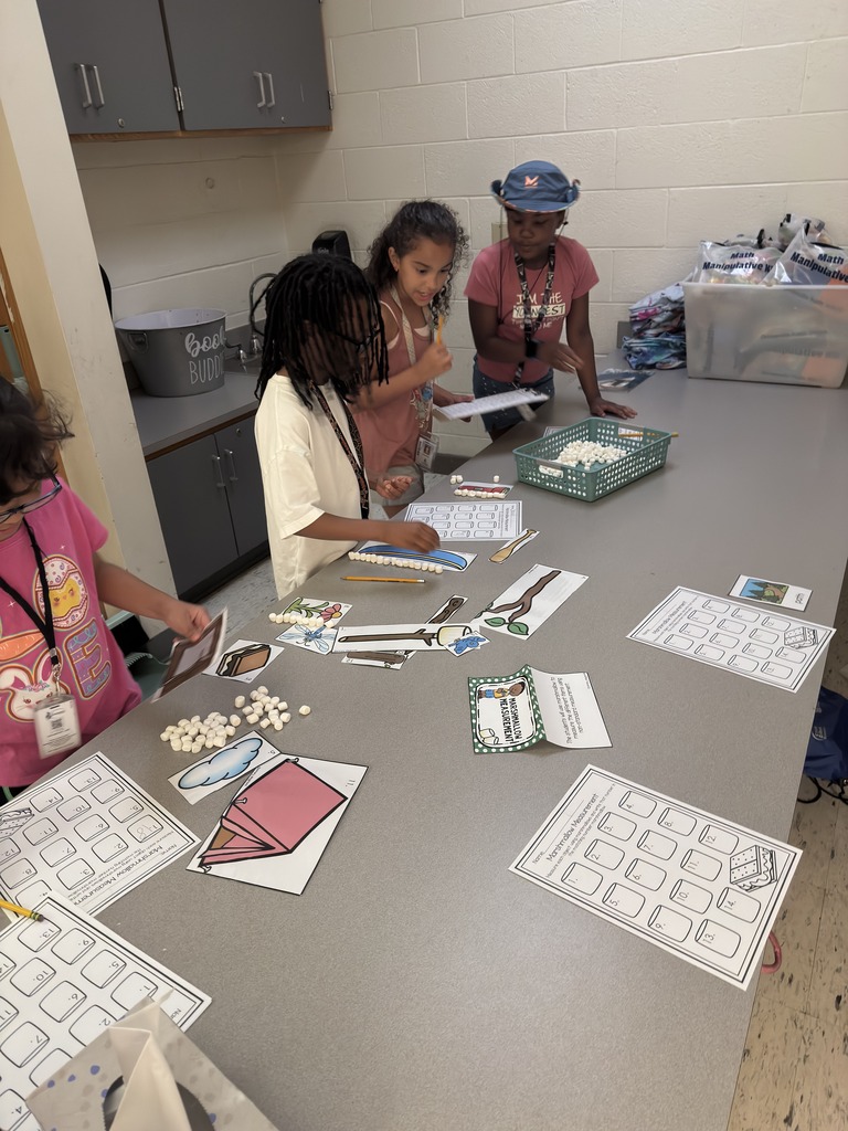 students measuring with marshmallows as their unit of measurement