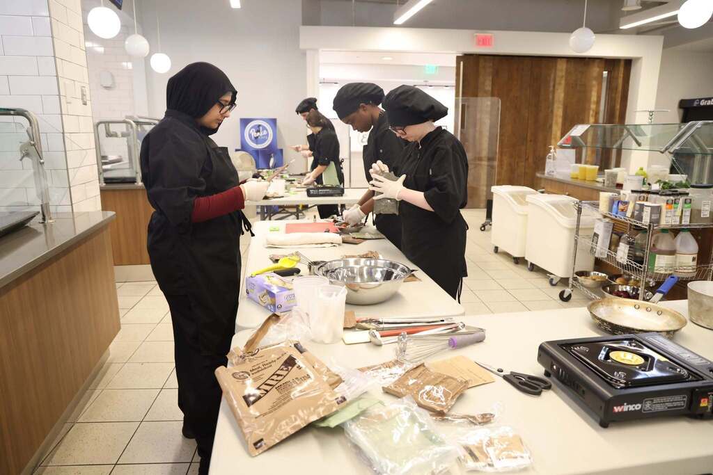 students work hard to prepare meals