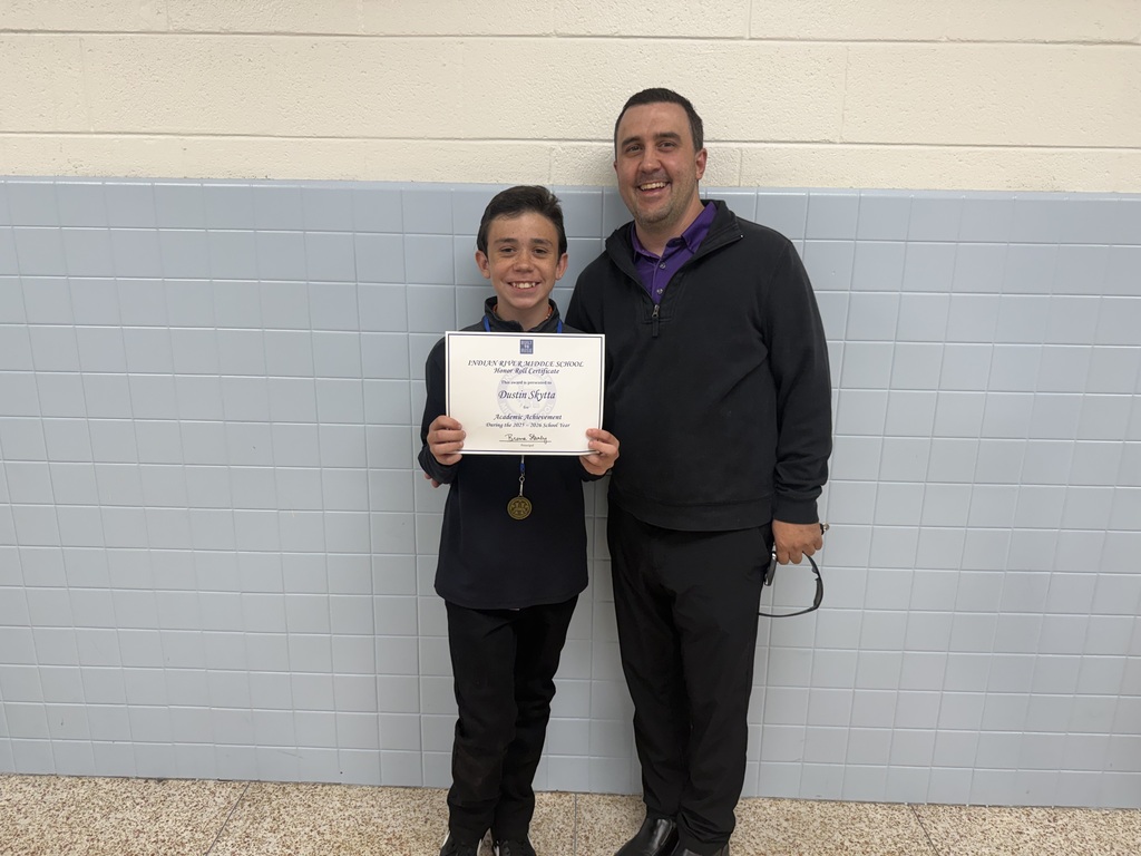 Student and family receiving recognition during the school's 2025–2026 Academic Awards Ceremony.