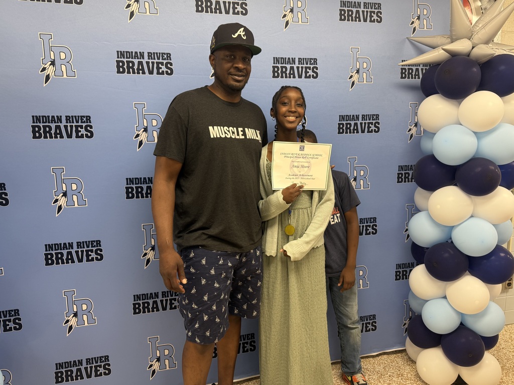 Student and family receiving recognition during the school's 2025–2026 Academic Awards Ceremony.