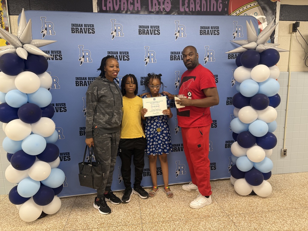 Student and family receiving recognition during the school's 2025–2026 Academic Awards Ceremony.