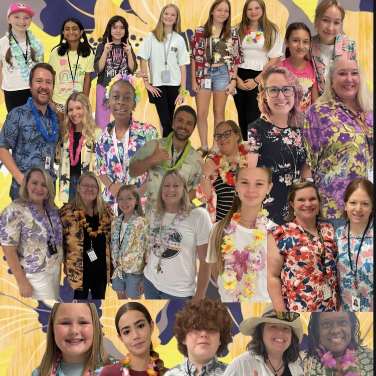 students and staff standing in a Hawaiian T-shirt, smiling