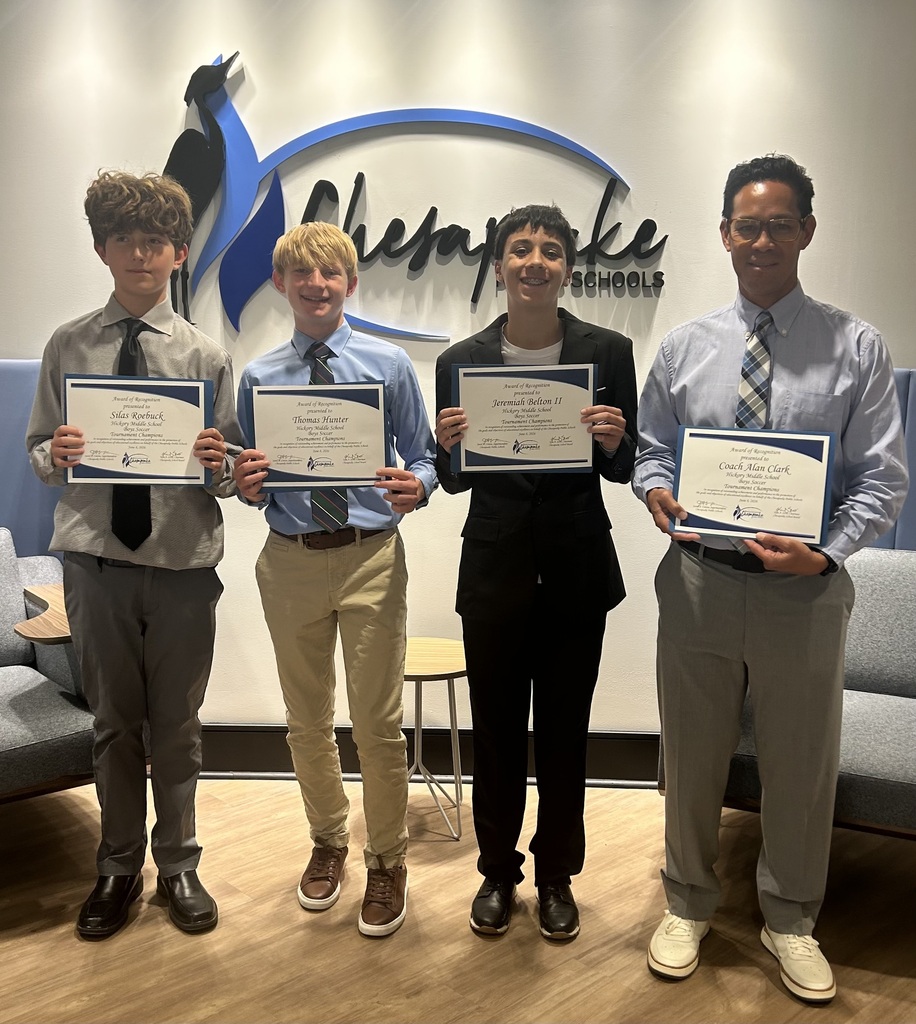 Members of our boys soccer team and coach proudly holding their certificates of recognition for their outstanding season